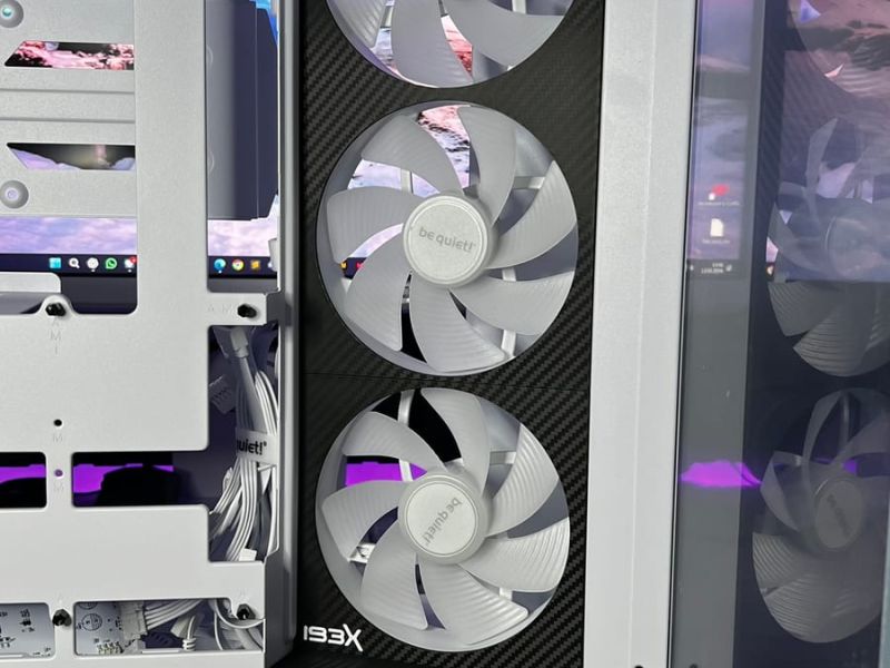 The side fans behind the printed carbon-texture panel