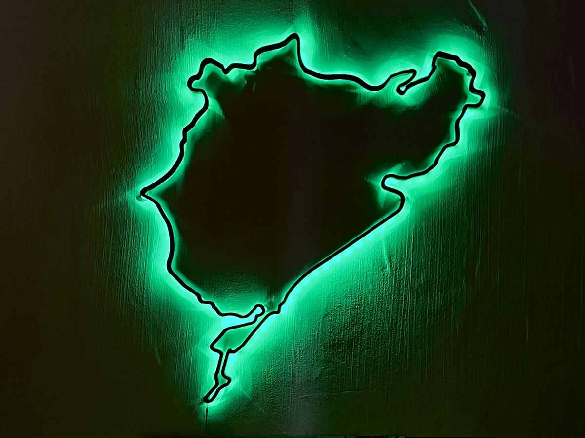The Nordschleife wall art glowing green on a dark wall