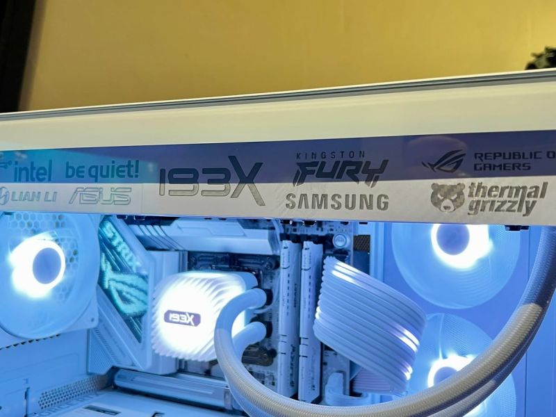 The white radiator cover fitted in the case, brand lettering along its length, lit from inside