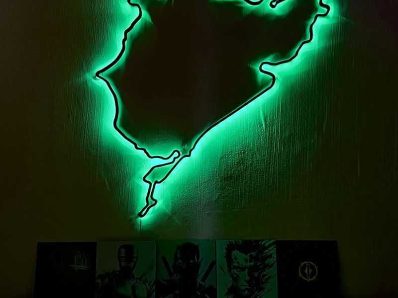 The Nordschleife wall art glowing green above a sideboard
