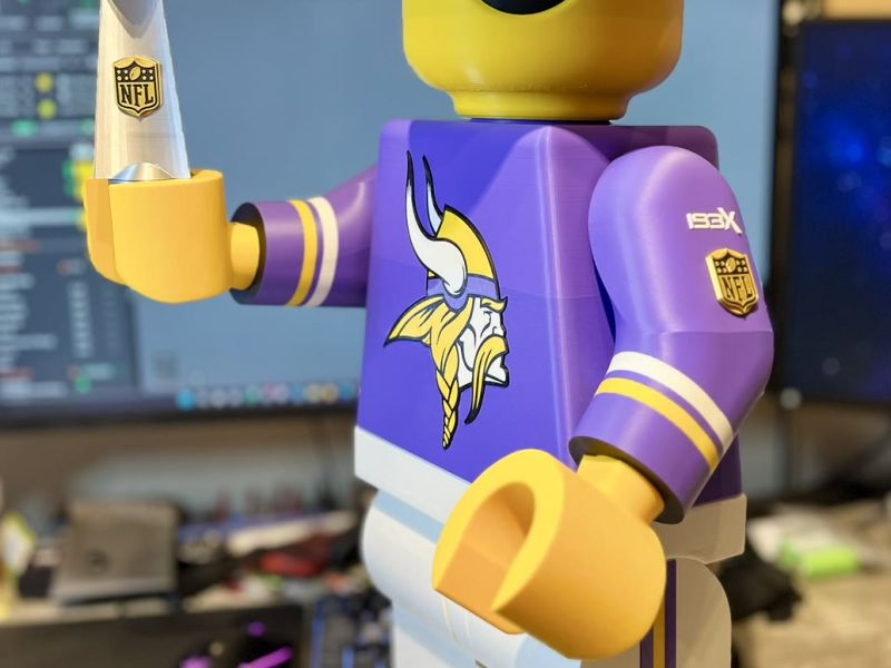 The smiling Brickman holding the Super Bowl trophy