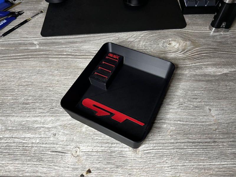 Black centre console tray with a red GT logo and a coin holder with the IBEX logo