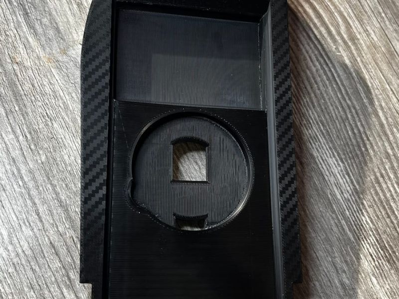 The printed insert with the empty MagSafe mount and the white M logo