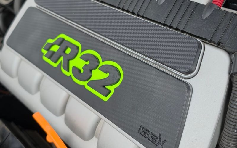 3D-printed R32 plate in black and neon green on the intake manifold of the VR6