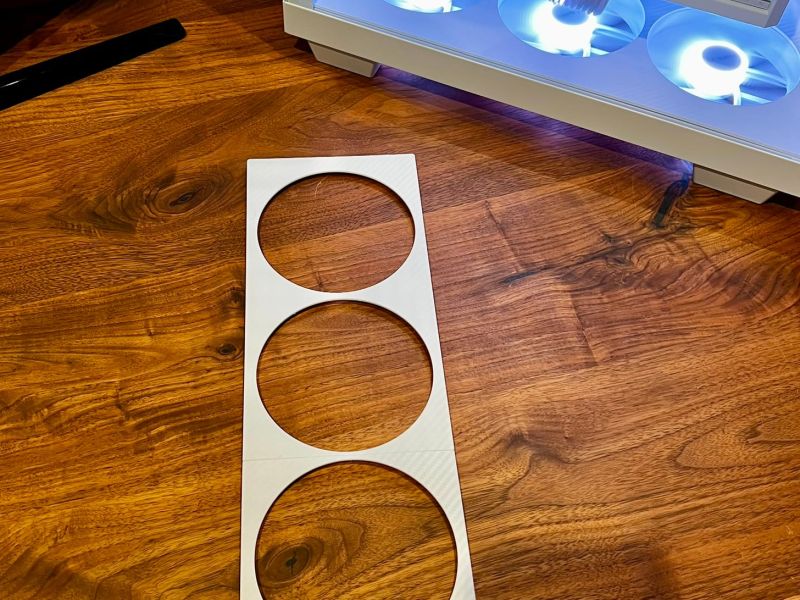 The white side fan cover off the case, in front of the finished build