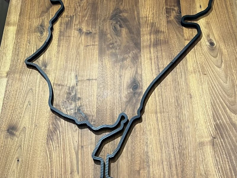 The finished track in black PETG on a walnut table