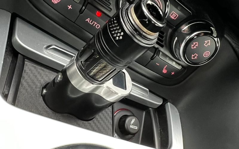 The Dani Box sitting in the vape ashtray insert of the Audi TT