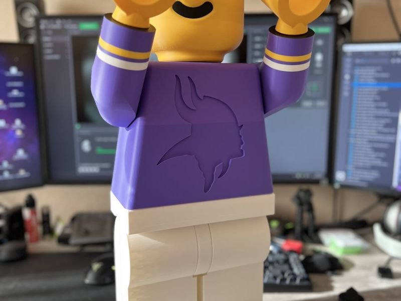 The Brickman with both arms up