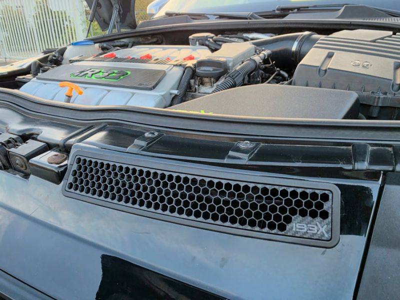Black honeycomb insert with the IBEX logo in the slot above the grille