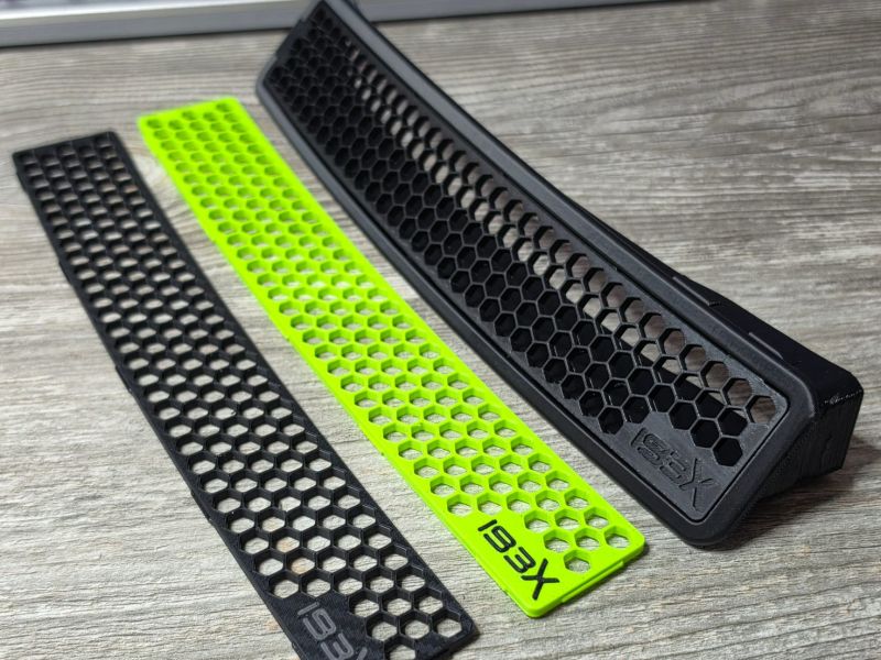 Three printed parts: black mesh, lime mesh and the black frame