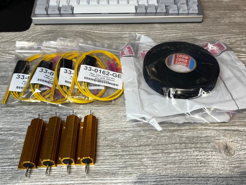 Resistors, repair connectors 1J0 973 802 and fabric tape laid out before soldering