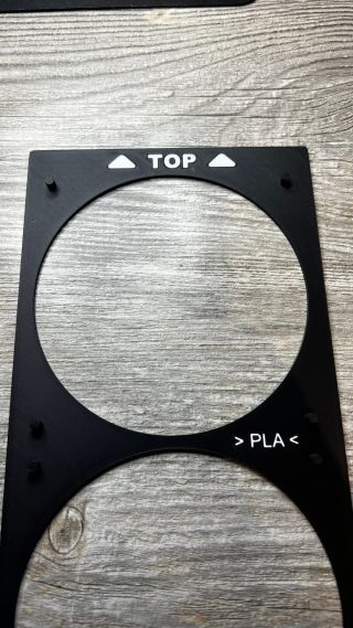 Back of the side cover with TOP marking for the assembly instructions