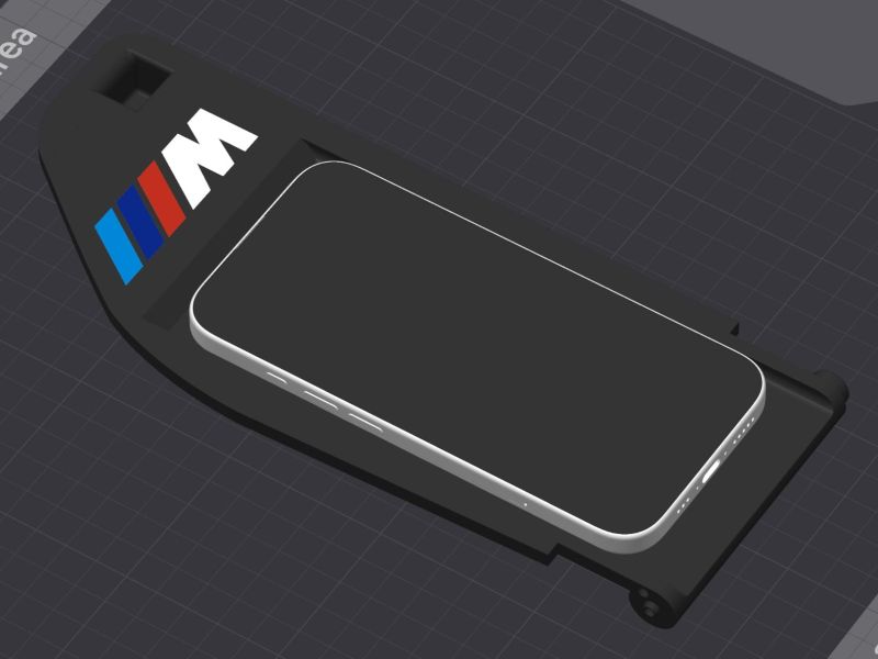 CAD render of the console insert with an iPhone on the MagSafe pad and the M stripes