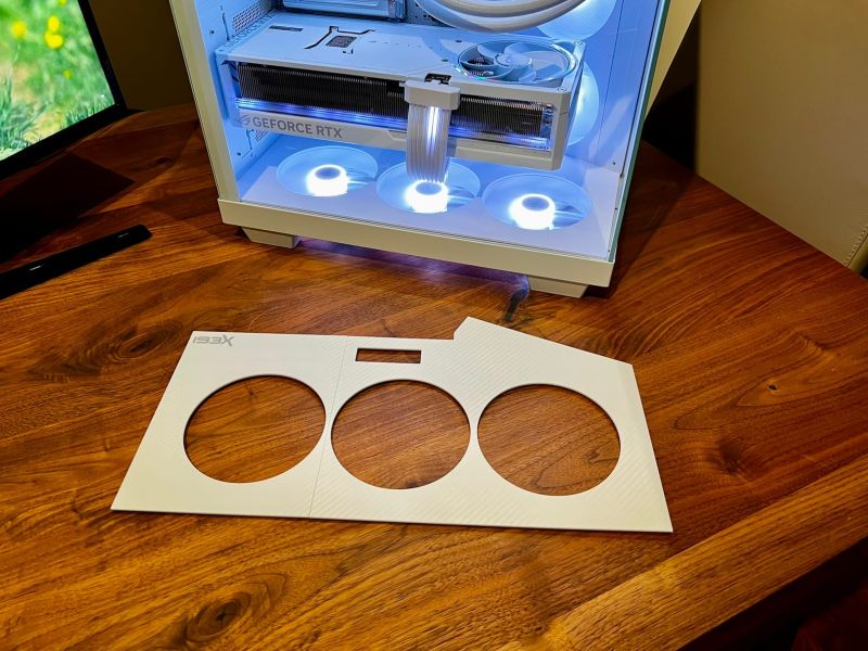 The white bottom plate with the cable cutout, in front of the finished build