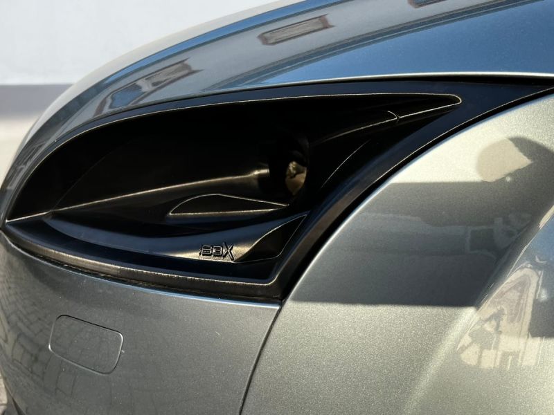 The intake behind the headlight lens with the IBEX logo