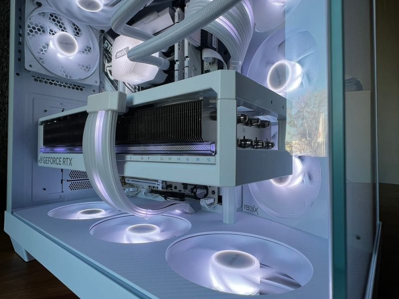 The white bottom plate under the lit bottom fans, below the graphics card