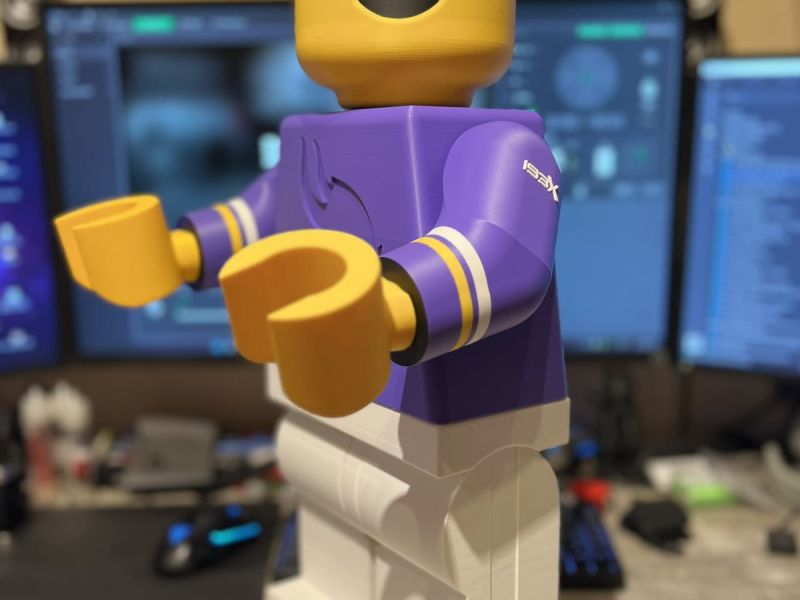 The unfinished Brickman with his arms reaching forward