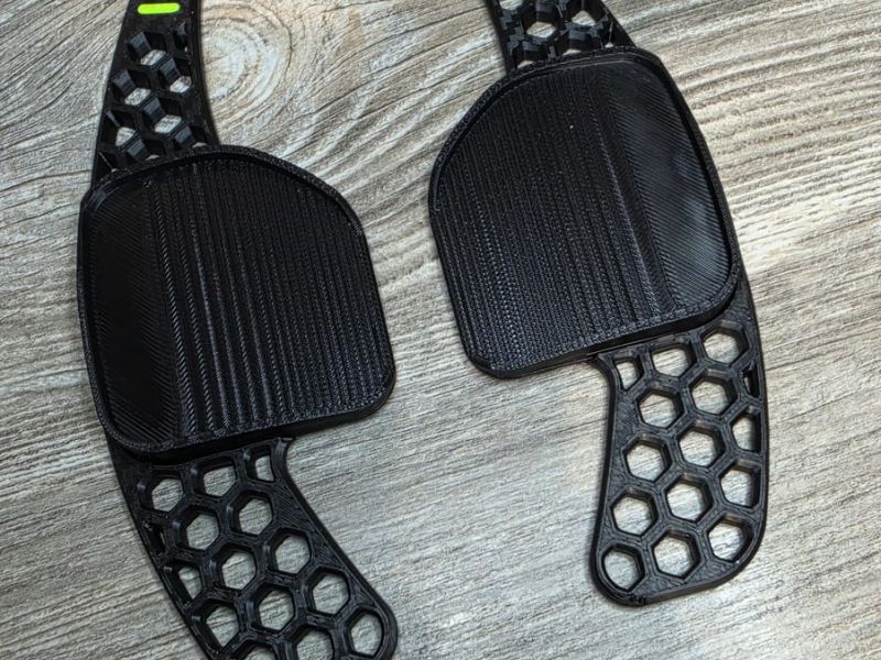Honeycomb paddle shifters in black with neon green plus and minus