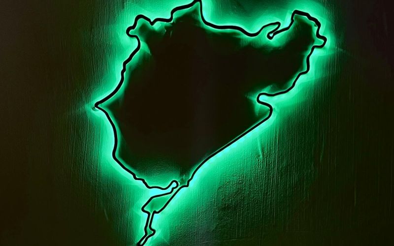The Nordschleife wall art glowing green on a dark wall