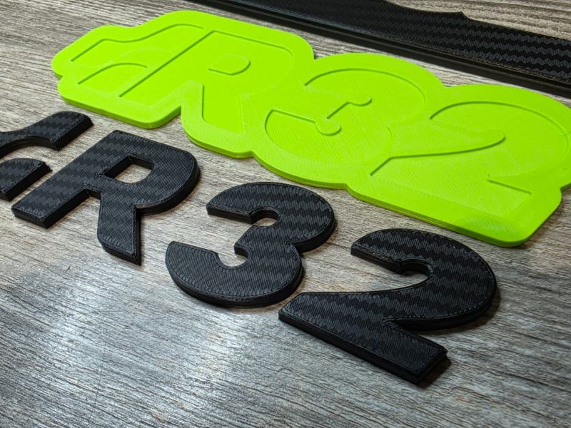 Close-up of the green and black R32 logos