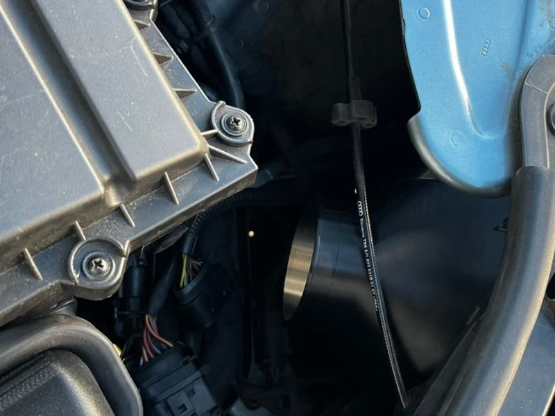 The duct routed behind the headlight into the engine bay